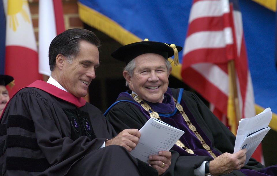 FILE - Pat Robertson, right, the founder of Christian Broadcasting Network and the chancellor of Regent University, sits with Republican presidential hopeful Mitt Romney, the former governor of Massachusetts, before Romney delivers the commencement address to the 2007 graduating class of Regent University in Virginia Beach, Va., on May 5, 2007. Robertson died Thursday, June 8, 2023. (AP Photo/Gary C. Knapp, File)