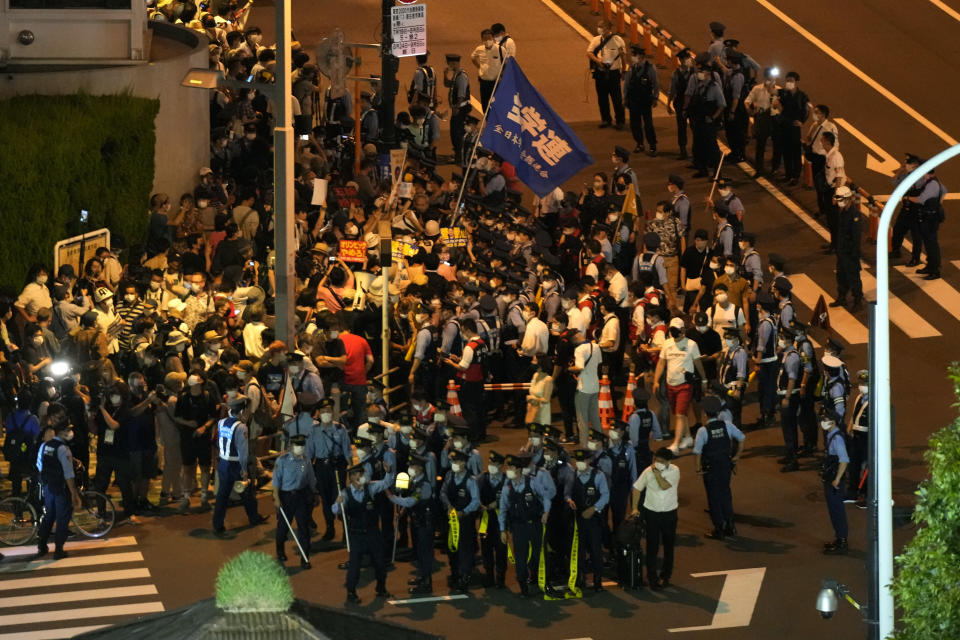 <p>Protesters stage a rally outside the National Stadium, before the opening ceremony starts at the 2020 Summer Olympics, Friday, July 23, 2021, in Tokyo. (AP Photo/Shuji Kajiyama)</p> 