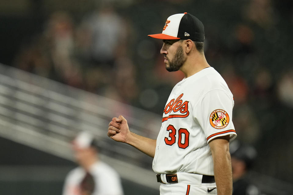 Baltimore Orioles starting pitcher Grayson Rodriguez reacts after center fielder Cedric Mullins made a catch on a ball hit by Chicago White Sox's Yoan Moncada during the fifth inning of a baseball game, Monday, Aug. 28, 2023, in Baltimore. (AP Photo/Julio Cortez)