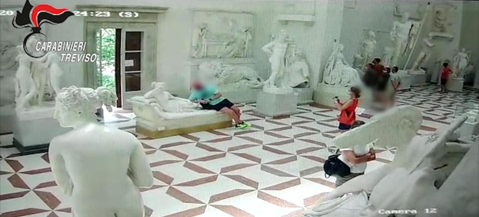 CCTV footage released by Italian Carabinieri military police shows a tourist posing for a photograph while leaning on a 19th-century plaster model of 
