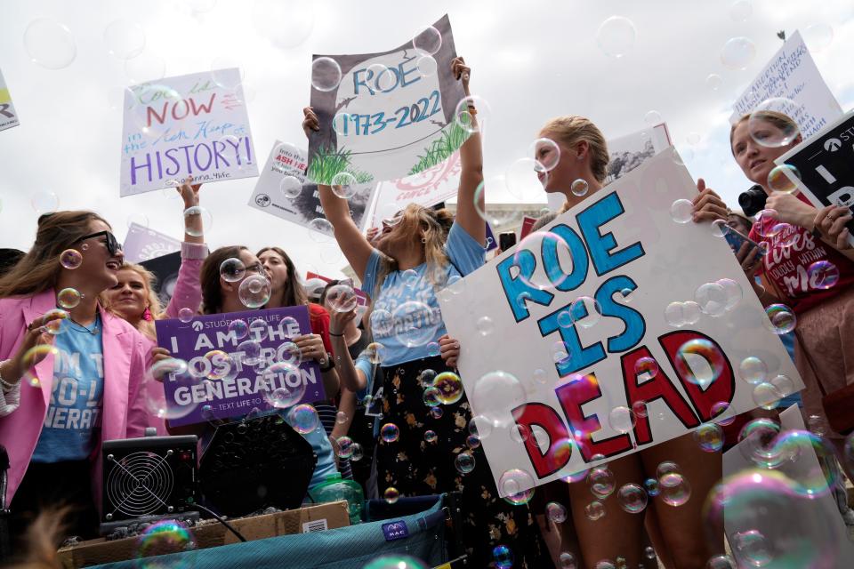 Anti-abortion demonstrators react outside the Supreme Court in Washington, Friday, June 24, 2022 after the decision in Dobbs v. Jackson Women's Health Organization overturned the landmark 1973 Roe v. Wade decision that established a constitutional right to abortions.