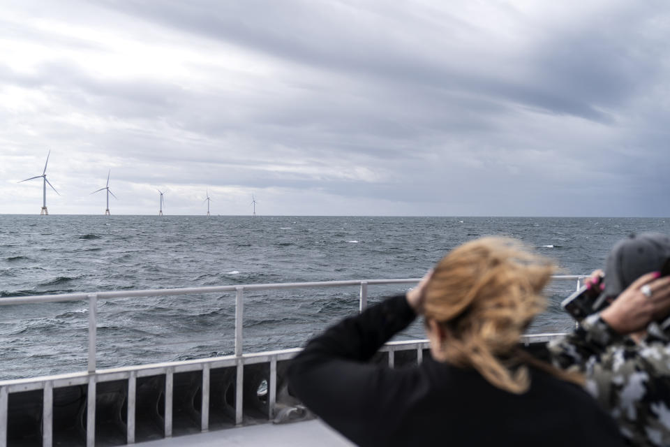 FILE - Guests tour the five turbines of America's first offshore wind farm, owned by the Danish company, Orsted, off the coast of Block Island, R.I., as part of a wind power conference, Monday, Oct. 17, 2022. As the U.S. races to build offshore wind power projects that will transform coastlines from Maine to South Carolina, much remains unknown about how the facilities could affect the environment. And that has some people concerned, particularly those who depend on the sea for their livelihoods. (AP Photo/David Goldman, File)