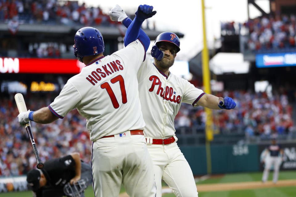Philadelphia Phillies' Bryce Harper, right, and Rhys Hoskins celebrate after Harper's home run during the seventh inning of a baseball game against the Atlanta Braves, Saturday, March 30, 2019, in Philadelphia. (AP Photo/Matt Slocum)