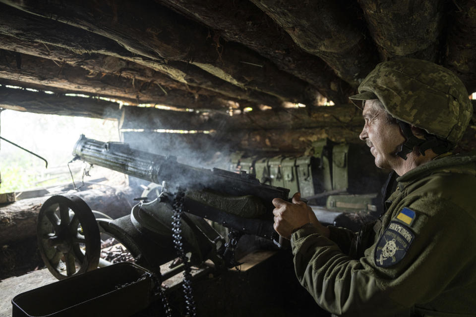 FILE - A Ukrainian serviceman of 28th brigade shoots a Maxim gun towards Russian positions at the frontline in Donetsk region, Ukraine, Wednesday, June 21, 2023. Ukrainian forces are making steady progress along the northern and southern flanks of Bakhmut, in a semi-encirclement of the wrecked city that Russian forces have been occupying since May. (AP Photo/Evgeniy Maloletka, File)