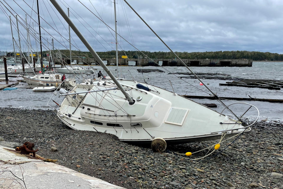 <p>A sailboat lies washed up on shore following the passing of Hurricane Fiona, later downgraded to a post-tropical storm, in Shearwater, N.S. on Sept. 24, 2022. (REUTERS/Eric Martyn)</p> 