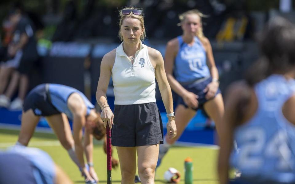 North Carolina field hockey coach Erin Matson walks amongst her players as they stretch prior to their overtime period against Iowa on Sunday, August 27, 2023 at Karen Shelton Stadium in Chapel Hill, N.C.