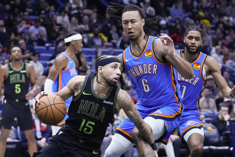 New Orleans Pelicans guard Jose Alvarado (15) drives around Oklahoma City Thunder forward Jaylin Williams (6) in the first half of an NBA basketball game in New Orleans, Friday, Jan. 26, 2024. (AP Photo/Gerald Herbert)