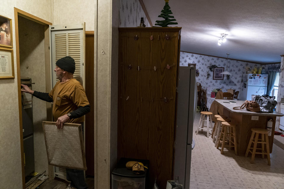 Jerry Barber changes a furnace filter in his house after receiving free filters from a donation bank on Feb. 17, 2023 in Darlington, Penn. (Michael Swensen / Getty Images)