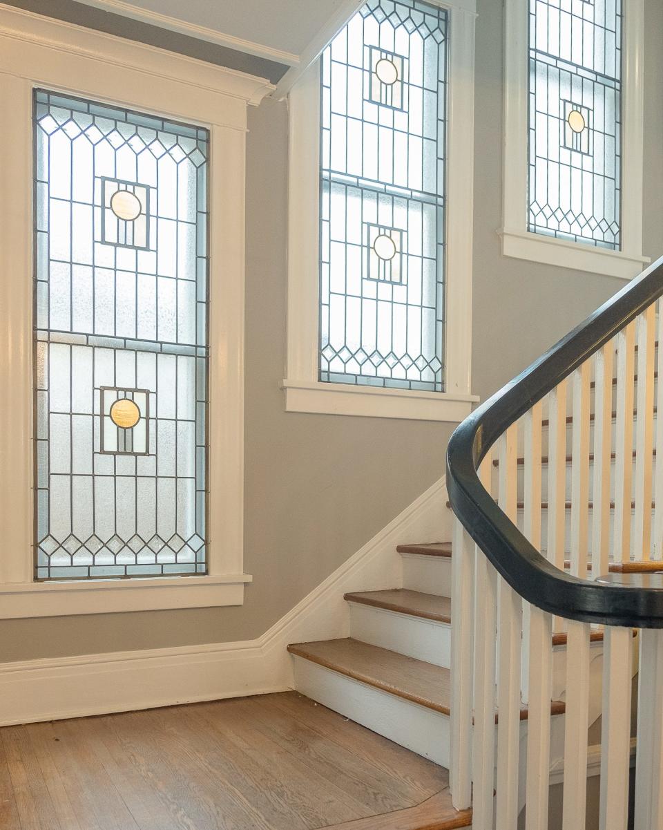 This staircase features beautiful stained glass panels.