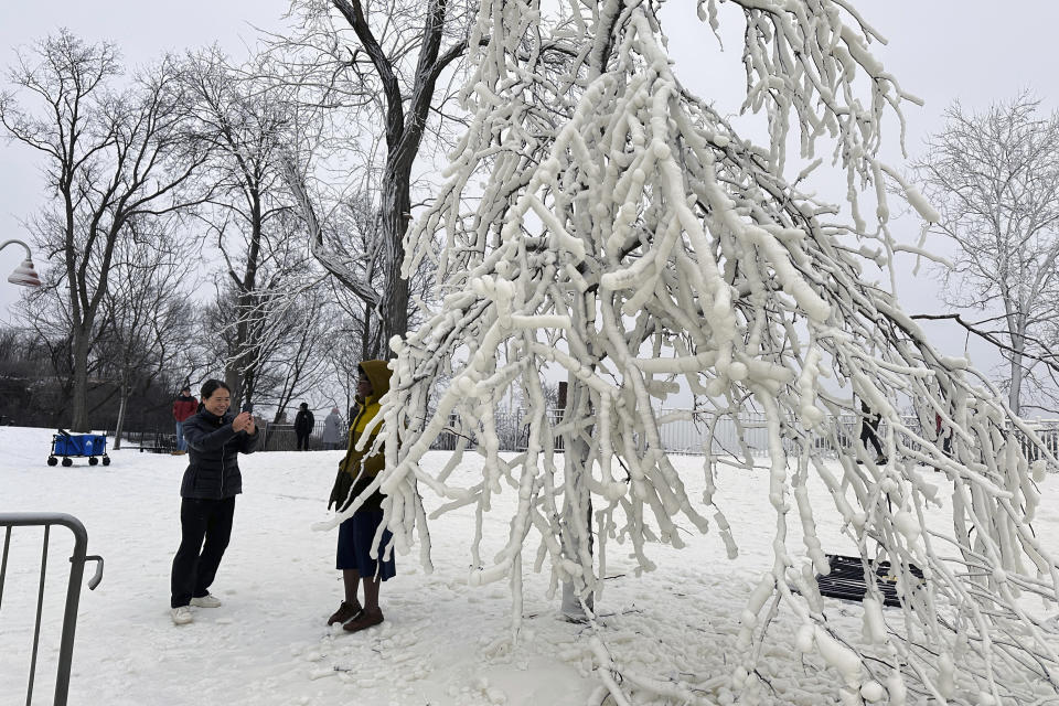 Mist from the Great Falls has created a frozen wonderland around the waterfalls in Paterson, N.J., on Thursday, Jan. 18, 2024. People are braving the subfreezing cold temps and slippery walkways to visit the ice-covered trees, benches and lamposts. (AP Photo/Ted Shaffrey)