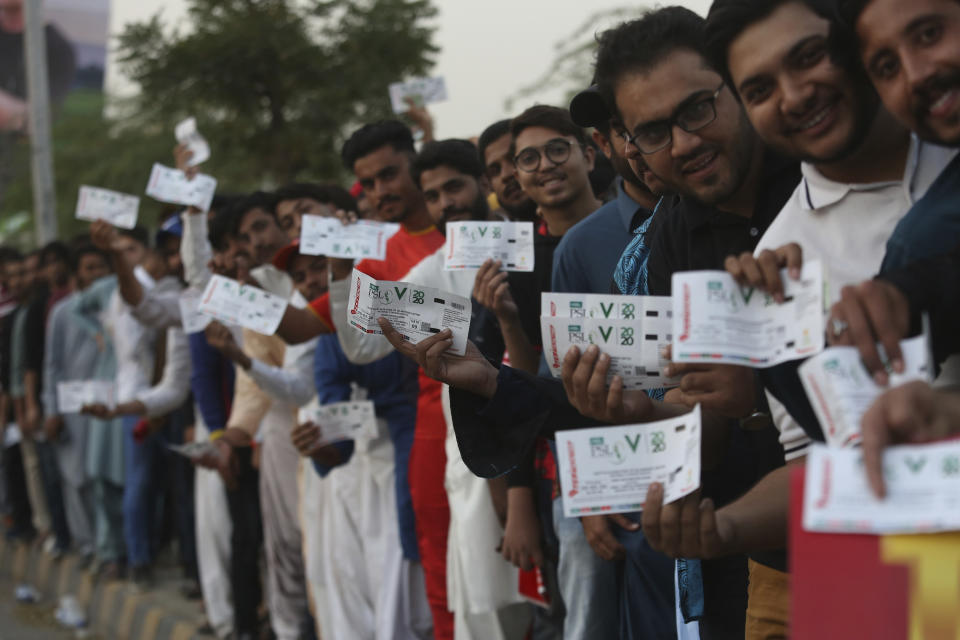 Pakistani cricket fans show their tickets stand in a queue to enter National Stadium to watch Pakistan Super League match in Karachi, Pakistan, Thursday, Feb. 20, 2020. (AP Photo/Fareed Khan)