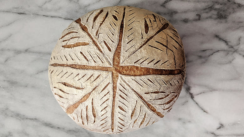 baked scored sourdough bread