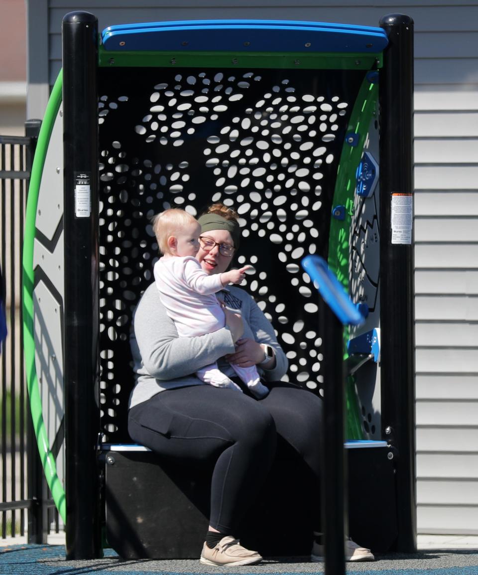 Autumn, right, and Leah Hilbert take a break from playtime in the "serenity spot" at Emmanuel Community Inclusive Park inSeymour on April 22. The new inclusive playground is open to the public on the campus of Emmanuel Lutheran Church. This space includes tactile activities, meant to help children calm down when overstimulated.