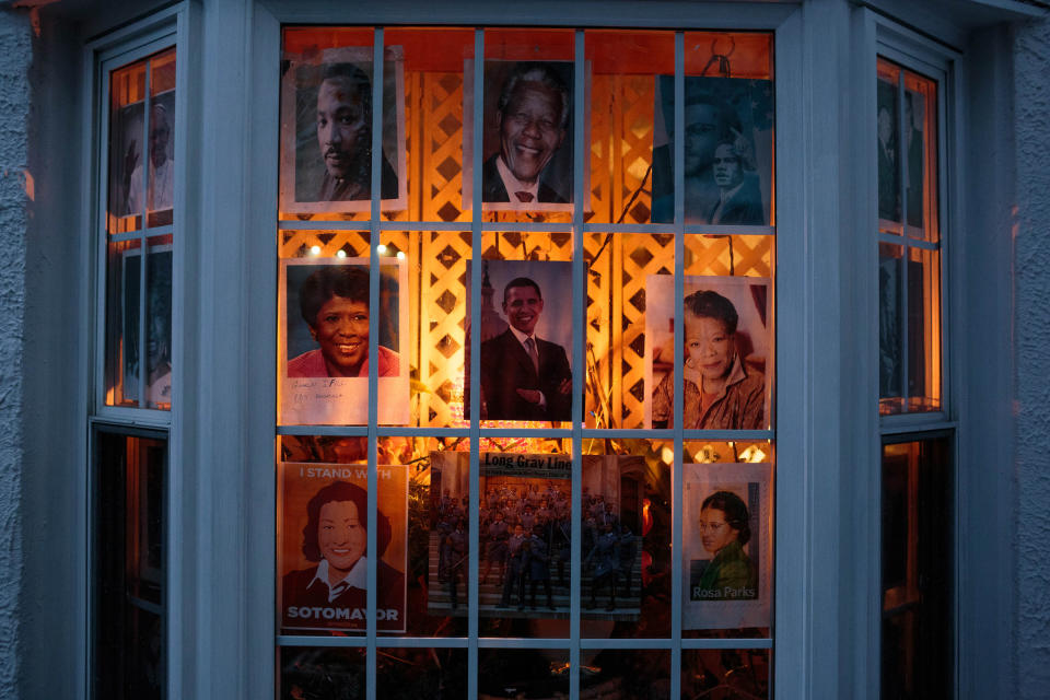 The front window of the Romey home in Bushwick is decorated with pictures of Blanche's idols, ranging from Obama, Rosa Parks, Pope Francis, and a recent photograph of young black women who were recently admitted into West Point. Blanche hopes that the young neighborhood kids walking by will notice them and find some inspiration. | Sarah Blesener