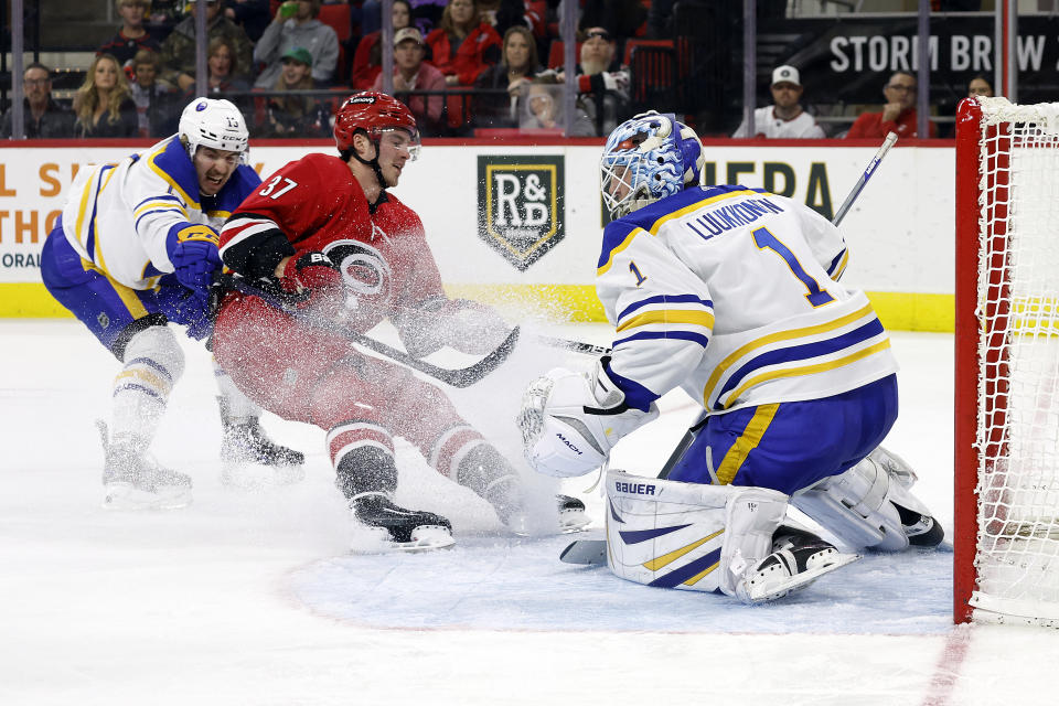 Carolina Hurricanes' Andrei Svechnikov (37) has his shot blocked by Buffalo Sabres goaltender Ukko-Pekka Luukkonen (1) as Sabres Lukas Rousek (13) defends during the second period of an NHL hockey game in Raleigh, N.C., Tuesday, Nov. 7, 2023. (AP Photo/Karl B DeBlaker)