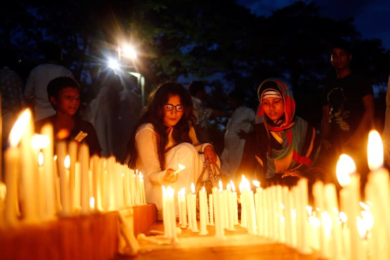 People attend a candlelight vigil to mark the first anniversary of the Holey Artisan Bakery attack in Dhaka