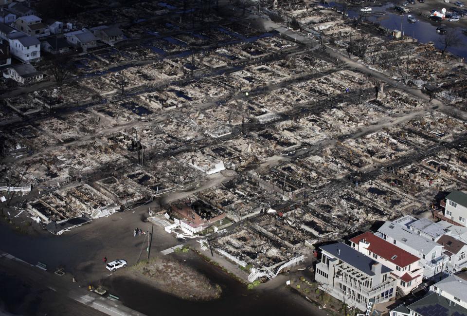 This aerial photo shows the Breezy Point neighborhood, in New York, Wednesday, Oct. 31, 2012, where more than 50 homes were burned to the ground Monday night as a result of superstorm Sandy. Sandy, the storm that made landfall Monday, caused multiple fatalities, halted mass transit and cut power to more than 6 million homes and businesses. (AP Photo/Mark Lennihan)