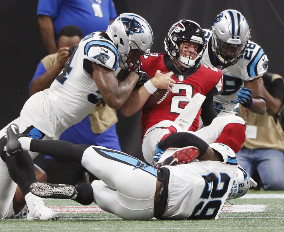 Atlanta Falcons quarterback Matt Ryan (2) muscles across the goal line through Carolina Panthers defenders on a keeper to score during the second half of an NFL football game, Sunday, Sept 16, 2018, in Atlanta. (Bob Andres/Atlanta Journal-Constitution via AP)