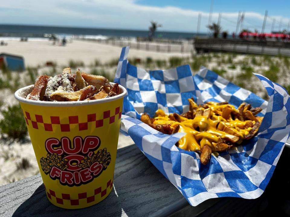 Boardwalk fries with garlic parmesan seasoning and classic cheese fries on the Seaside Heights boardwalk.