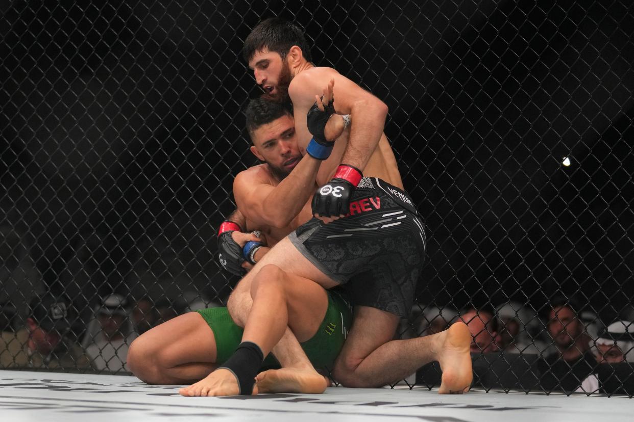 Magomed Ankalaev, right, moments before landing an illegal knee on Johnny Walker (AP)