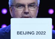 International Olympic Committee (IOC) president Thomas Bach shows the card with the name Beijing as the winning name of the 2022 Winter Olympic bid city