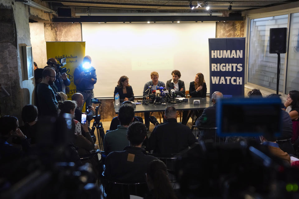 AFP video journalist Dylan Collins, second left, who was injured when an Israeli shell landed in a gathering of international journalists on Oct. 13, 2023, speaks during a press conference by Amnesty International and Human Rights Watch in Beirut, Lebanon, Thursday, Dec. 7, 2023. Two Israeli strikes that killed a Reuters videographer and wounded six other journalists in south Lebanon nearly two months ago were an apparent deliberate and direct attack on civilians "that must be investigated as a war crime," two international human rights groups said Thursday. (AP Photo/Bilal Hussein)