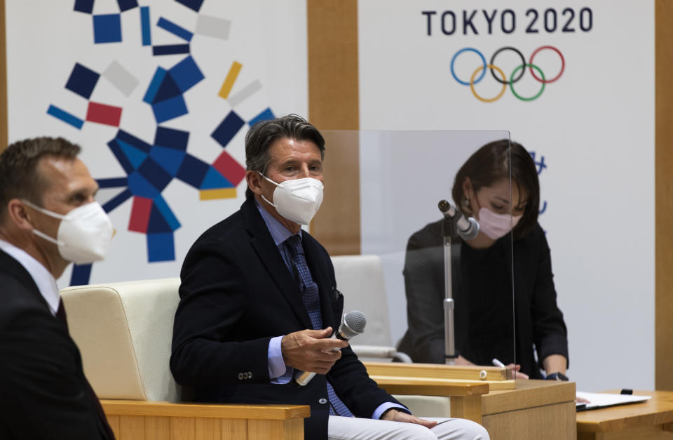 Sebastian Coe, center, the president of World Athletics, an internationally governing organization for the sport of athletics, watches the media leave the room as he starts to talk with Tokyo Gov. Yuriko Koike in Tokyo on Friday, May 7, 2021. Seiko Hashimoto, the president of the Tokyo Olympic organizing committee, said Friday IOC President Thomas Bach to make a planned visit this month to Japan with a state of emergency order being extended by the government until May 31 to Tokyo and other areas. (AP Photo/Hiro Komae)