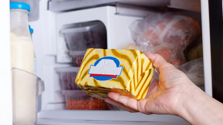 Person putting butter in freezer