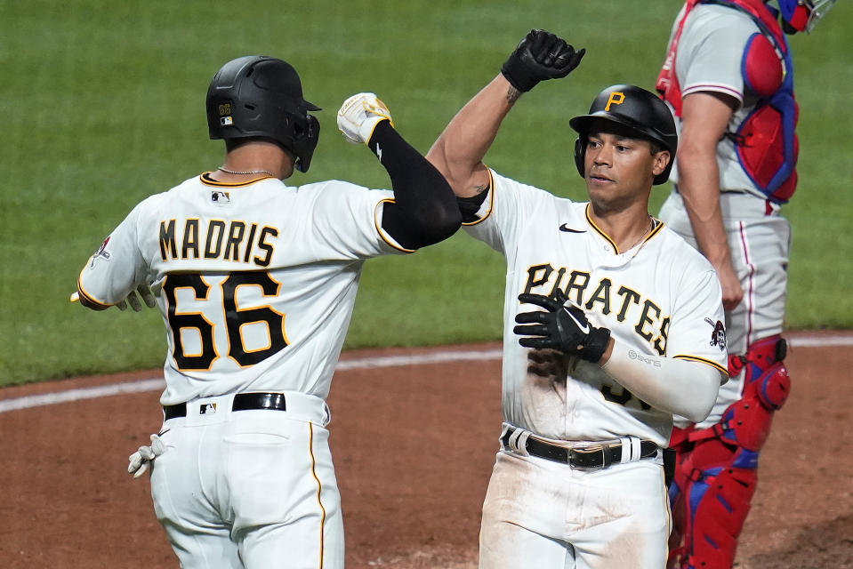 Pittsburgh Pirates' Cal Mitchell, right, celebrates with Bligh Madris after hitting a two-run home run off Philadelphia Phillies starting pitcher Zack Wheeler during the seventh inning of a baseball game in Pittsburgh, Thursday, July 28, 2022. (AP Photo/Gene J. Puskar)