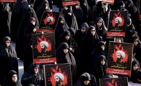 Iranian protesters hold pictures of prominent Shi'ite cleric Sheikh Nimr al-Nimr during a demonstration against the execution of al-Nimr in Saudi Arabia, at Imam Hussein square in Tehran January 4, 2016. REUTERS/Raheb Homavandi/TIMA