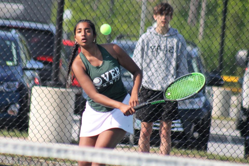 Dover's Riya Ramdev charges the net during Tuesday's semifinal playoff match against Hanover.