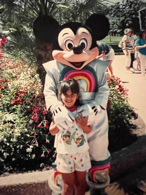 janette as a little girl posing with micky mouse
