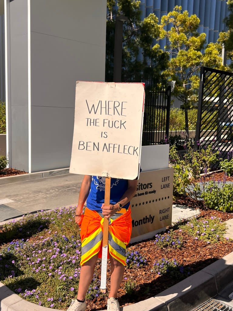 <em>A picketer holds a sign on July 15 at Netflix headquarters in Los Angeles. </em>