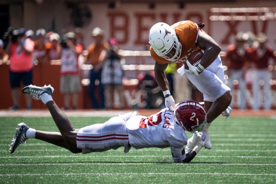 Texas running back Bijan Robinson (5) steps around a tackle from Alabama defensive back DeMarcco Hellams (2) during second half of the Longhorns game against the Alabama Crimson Tide at Royal-Memorial Stadium in Austin on Saturday, Sept. 10, 2022. Alabama won the game 20-19 with a late field goal.