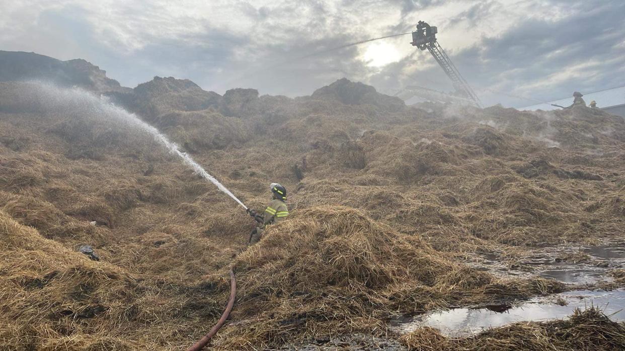 Firefighters are pictured Thursday, Nov. 24, 2022, at the scene of a fire that struck two barns full of straw near the intersection of M-156 and Ridgeville Road, just north of Morenci.
