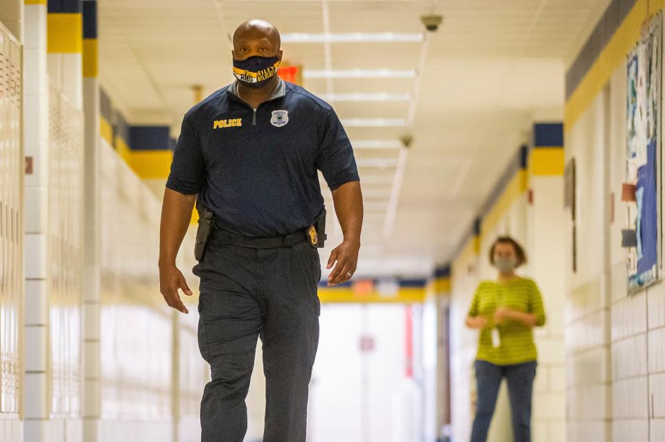 Anthony Pearson, Schools Resource Officer at Riley High School, walks the hallways on Friday, May 21, 2021, at Riley High School in South Bend.
