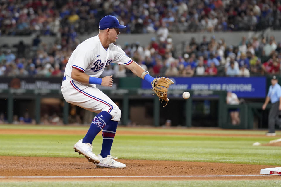 Texas Rangers third baseman Josh Jung fields a ground ball hit by Boston Red Sox's Connor Wong in the fifth inning of a baseball game in Arlington, Texas, Monday, Sept. 18, 2023. Wong was out at first base on the play. (AP Photo/Tony Gutierrez)