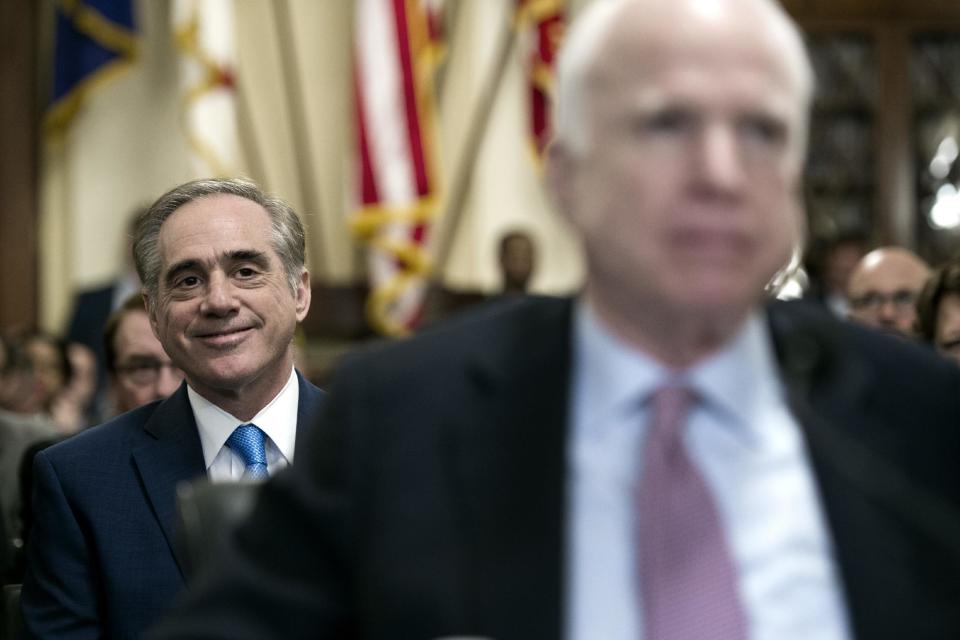 Department of Veterans Affairs Secretary David Shulkin, left, watches as Sen. John McCain, R-Az., addresses a House Veterans Affairs Committee hearing on veterans commuity care, on Captiol Hill in Washington, Tuesday, March 7, 2017. (AP Photo/Cliff Owen)