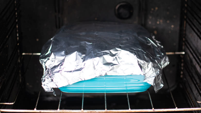 foil covered baking dish in oven
