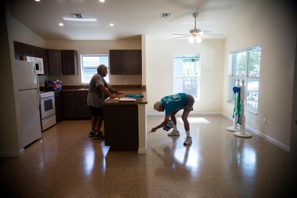 Habitat for Humanity of Martin County construction director Ron Morrow (left) and volunteer Stu Davis put the finishing touches on the nonprofit's 150th home built in the county on Thursday, July 15, 2021, in the Carter Park community in Indiantown. The nonprofit's mission is to provide low-income families with affordable home ownership. 