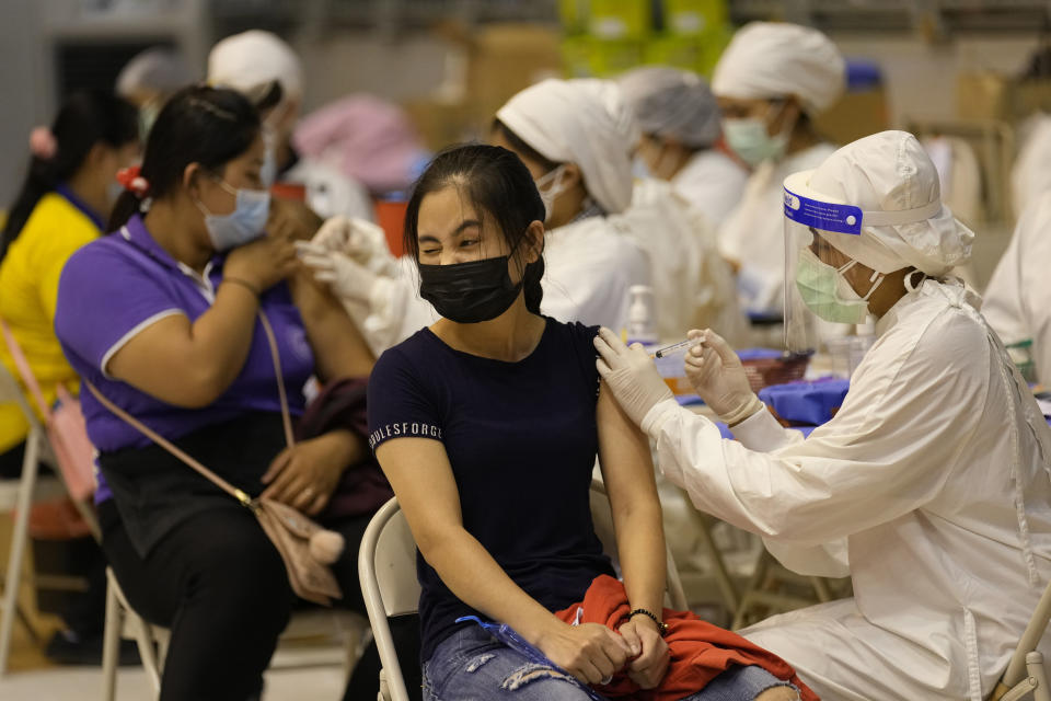 A health worker administers a dose of the Sinovac COVID-19 vaccine to a woman on Phuket, southern Thailand, Monday, June 28, 2021. Thailand's government will begin the "Phuket Sandbox" scheme to bring the tourists back to Phuket starting July 1. Even though coronavirus numbers are again rising around the rest of Thailand and prompting new lockdown measures, officials say there's too much at stake not to forge ahead with the plan to reopen the island to fully-vaccinated travelers. (AP Photo/Sakchai Lalit)