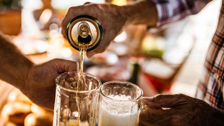 Man pours beer in glass