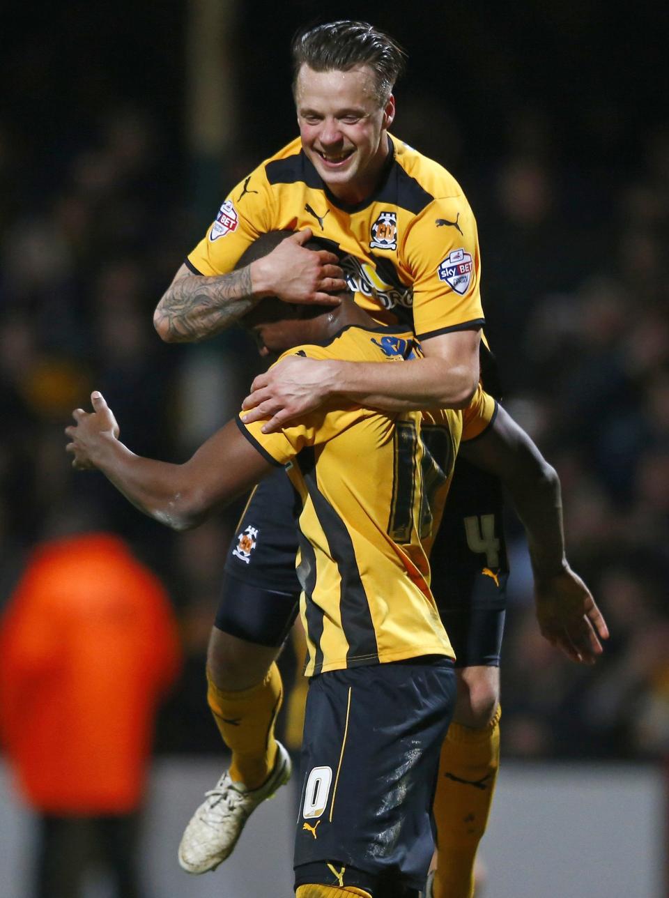 Cambridge United's Josh Coulson (top) celebrates with Tom Elliott at the final whistle of their English FA Cup 4th round soccer match against Manchester United at The Abbey Stadium in Cambridge, eastern England January 23, 2015. REUTERS/Andrew Winning (BRITAIN - Tags: SPORT SOCCER)