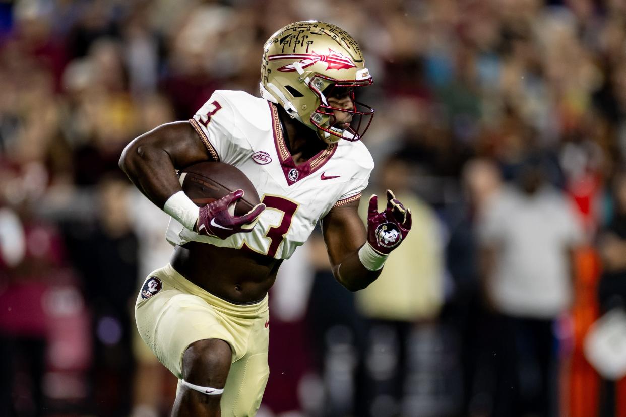Florida State Seminoles running back Trey Benson (3) rushes with the ball during the first half against the Florida Gators at Steve Spurrier Field at Ben Hill Griffin Stadium in Gainesville, FL on Saturday, November 25, 2023. [Matt Pendleton/Gainesville Sun]