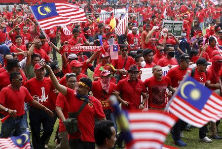 "Red Shirt" demonstrators gather for a rally to celebrate Malaysia Day and to counter a massive protest held over two days last month that called for Prime Minister Najib Razak's resignation over a graft scandal, in Malaysia's capital city of Kuala Lumpur September 16, 2015. REUTERS/Olivia Harris