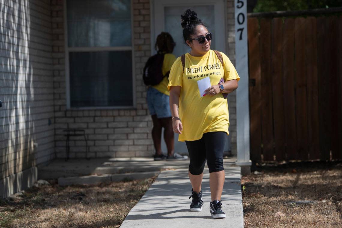 Amy Solis, a member of a new parent advocacy organization that’s part of the Powerful Parents Movement, knocks on doors in the Stop Six neighborhood to get other parents’ thoughts on schools in Fort Worth, Texas, on Saturday, Aug. 13, 2022.