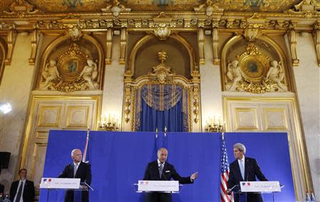 U.S. Secretary of State John Kerry (R) and British Foreign Secretary William Hague (L) listen to French Foreign Minister Laurent Fabius speak at a news conference after a meeting regarding Syria, at the Quai d'Orsay in Paris September 16, 2013. REUTERS/Larry Downing