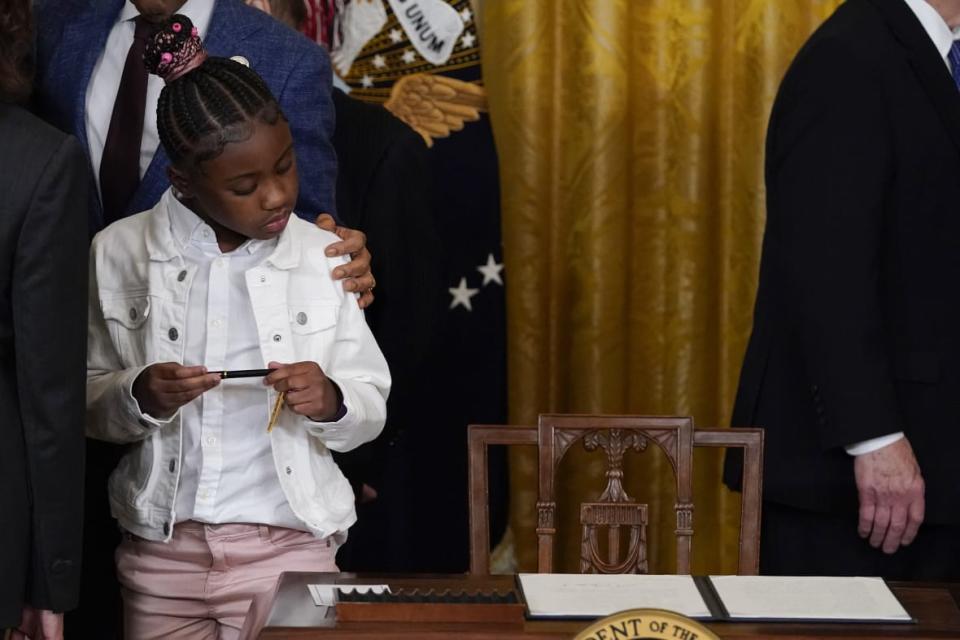 Gianna Floyd, the daughter of George Floyd, looks at the executive order on policing that President Joe Biden signed on May 25, 2022 in the East Room of the White House in Washington, D.C. The order came on the second anniversary of George Floyd’s death and is focused on policing. (AP Photo/Alex Brandon, File)
