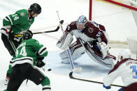 Dallas Stars right wing Denis Gurianov (34) scores a goal against Colorado Avalanche goaltender Darcy Kuemper (35) as Stars left wing Jamie Benn (14) watches during the second period of an NHL hockey game in Dallas, Friday, Nov. 26, 2021. (AP Photo/LM Otero)