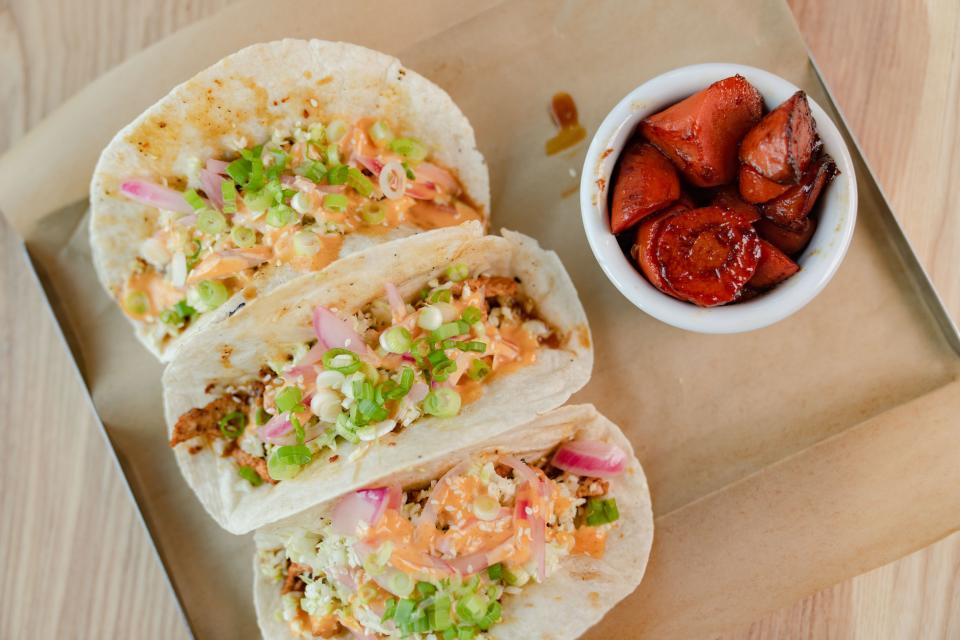 The Tokyo tacos, left, come with shoyu sauce at SingleSpeed Brewing Co. in Des Moines. Diners can opt for honey-glazed carrots as a side dish.